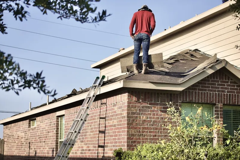 Professional roofer working on a residential roof in Bailey's Crossroads